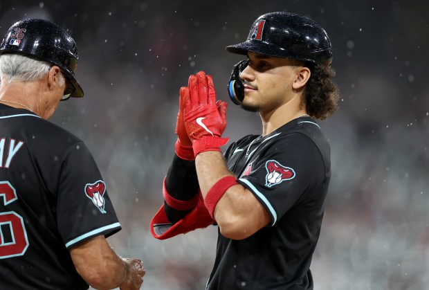Arizona Diamondbacks center fielder Alek Thomas celebrates at first base after driving in a run on a single in the seventh inning of a game against the Chicago White Sox at Rate Field in Chicago on June 24, 2025. (Chris Sweda/Chicago Tribune)