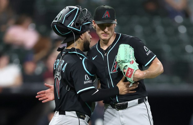 Arizona Diamondbacks catcher Jose Herrera (left) and relief pitcher Shelby Miller celebrate after securing a victory by closing out the Chicago White Sox in the ninth inning of a game at Rate Field in Chicago on June 24, 2025. (Chris Sweda/Chicago Tribune)