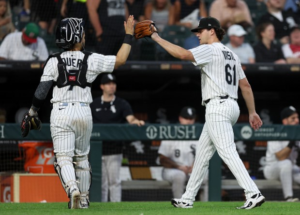 Chicago White Sox catcher Edgar Quero and relief pitcher Mike Vasil (61) congratulate one another after shutting down the Arizona Diamondbacks in the sixth inning of a game at Rate Field in Chicago on June 24, 2025. (Chris Sweda/Chicago Tribune)
