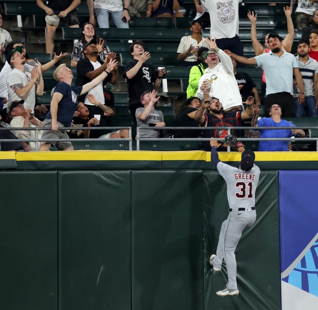 Detroit Tigers left fielder Riley Greene (31) scales the wall as he watches the flight of Chicago White Sox center fielder Michael A. Taylor's three-run home run in the sixth inning of a game at Rate Field in Chicago on June 3, 2025. (Chris Sweda/Chicago Tribune)