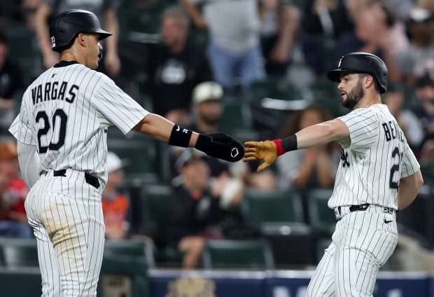 The White Sox's Miguel Vargas, left, and Andrew Benintendi congratulate one another after scoring on a double by Austin Slater against the Tigers on June 3, 2025, at Rate Field. (Chris Sweda/Chicago Tribune)