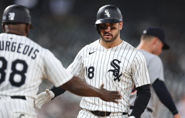 Chicago White Sox right fielder Mike Tauchman (18) is congratulated by first base coach Jason Bourgeois (38) after Tauchman drove in a run on a single in the eighth inning of a game against the Detroit Tigers at Rate Field in Chicago on June 3, 2025. (Chris Sweda/Chicago Tribune)