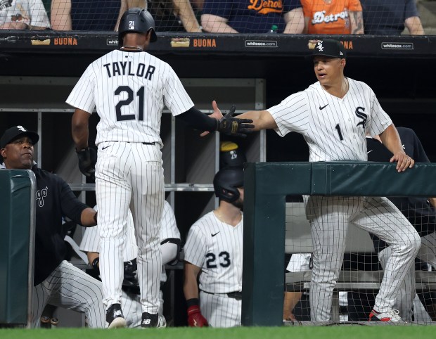 Chicago White Sox center fielder Michael A. Taylor (21) is congratulated by Chicago White Sox manager Will Venable (1) after Taylor scored a run in the eighth inning of a game against the Detroit Tigers at Rate Field in Chicago on June 3, 2025. (Chris Sweda/Chicago Tribune)