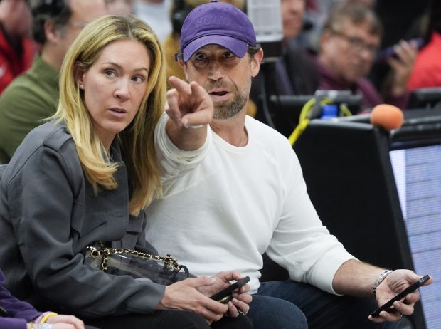 Phoenix Suns owner Justin Ishbia, right, and wife Kristen Ishbia, center, sit courtside during the first half of an NBA basketball game against the Chicago Bulls, Saturday, Feb. 22, 2025, in Chicago. (AP Photo/Erin Hooley)