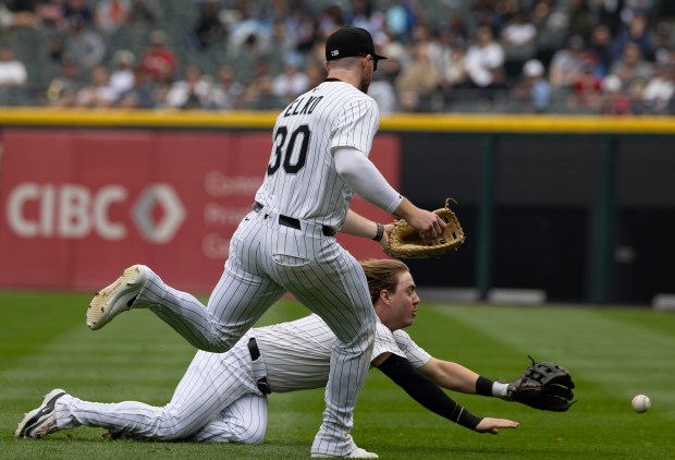White Sox second baseman Chase Meidroth can't catch a fly ball next to first baseman Tim Elko (30) as Tigers second baseman Colt Keith ties the game with an RBI single in the seventh inning on June 5, 2025, at Rate Field. (Brian Cassella/Chicago Tribune)