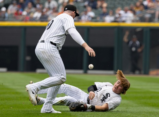 White Sox second baseman Chase Meidroth can't catch a fly ball next to first baseman Tim Elko (30) as Tigers second baseman Colt Keith ties the game with an RBI single in the seventh inning on June 5, 2025, at Rate Field. (Brian Cassella/Chicago Tribune)