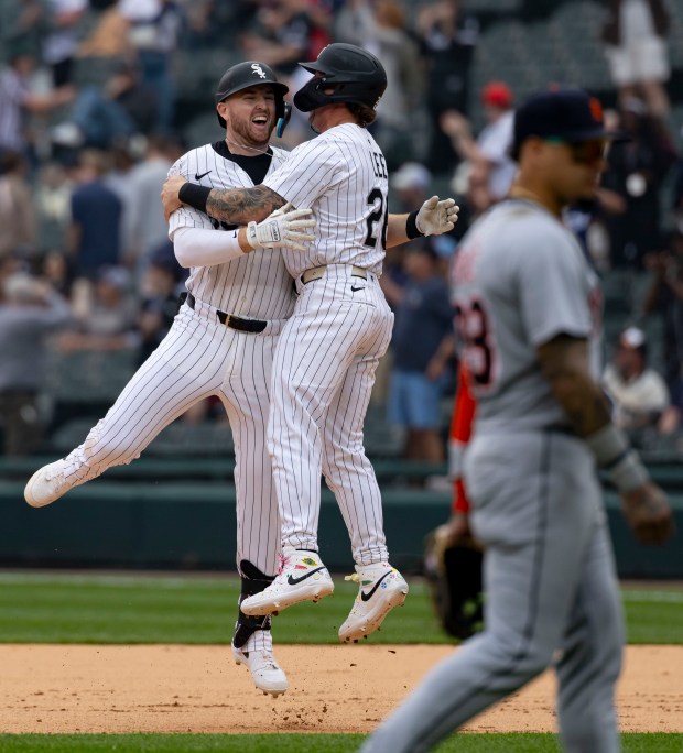 Chicago White Sox first baseman Tim Elko celebrates his game-winning hit with catcher Korey Lee (26) in the tenth inning as Detroit Tigers outfielder Javier Báez walks off the field Thursday, June 5, 2025, at Rate Field. (Brian Cassella/Chicago Tribune)