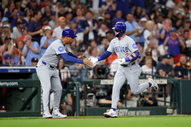 Third base coach Quintin Berry #0 of the Chicago Cubs congratulates Nico Hoerner #2 after a home run in the fifth inning against the Houston Astros at Daikin Park on June 27, 2025 in Houston, Texas. (Photo by Tim Warner/Getty Images)