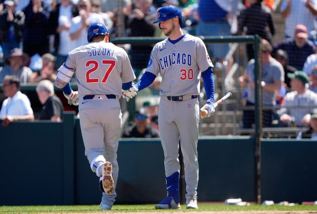Cubs right fielder Seiya Suzuki (27) slaps hands with designated hitter Kyle Tucker after hitting a solo home run against the Athletics in the top of the fourth inning on April 2, 2025, in West Sacramento, Calif. (Thearon W. Henderson/Getty Images)