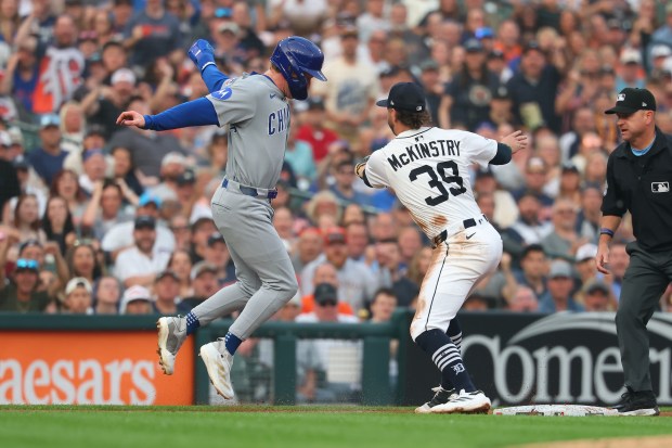 Cubs center fielder Pete Crow-Armstrong, left, is tagged out by Tigers third baseman Zach McKinstry while trying to get back to the base at Comerica Park on June 6, 2025, in Detroit. (Gregory Shamus/Getty Images)