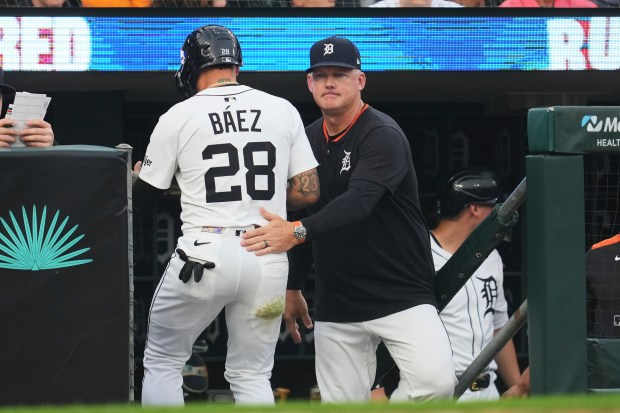 Tigers manager A.J. Hinch, right, congratulates Javier Báez after he scored against the Cubs in the fifth inning on June 6, 2025, in Detroit. (Paul Sancya/AP)