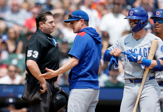 Chicago Cubs manager Craig Counsell, center, argues with home plate umpire Derek Thomas after Nico Hoerner, right, was ejected for arguing after being called out on strikes during the fifth inning of a baseball game Sunday, June 8, 2025, in Detroit. Counsell was also ejected from the game. (AP Photo/Duane Burleson)