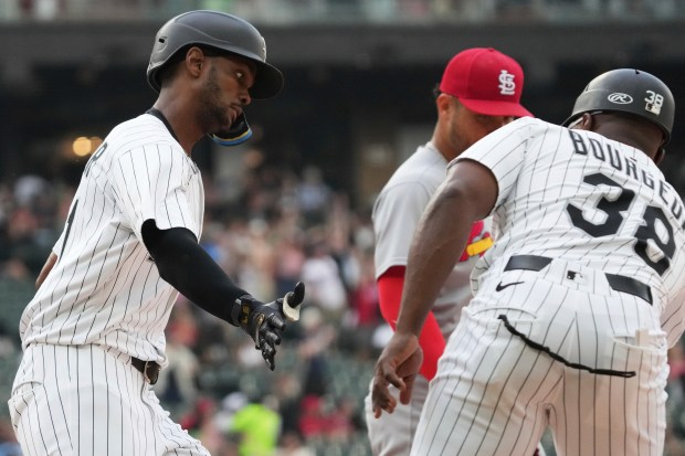 White Sox left fielder Michael A. Taylor, left, celebrates with first-base coach Jason Bourgeois after hitting a two-run home run in the sixth inning in the Game 1 of a doubleheader against the Cardinals on Thursday, June 19, 2025, at Rate Field. (Nam Y. Huh/AP)