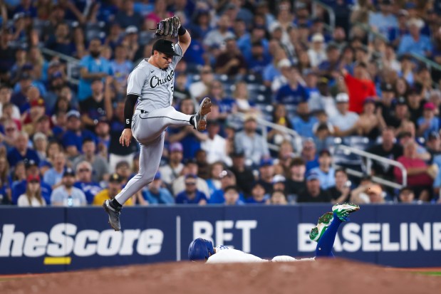 White Sox third baseman Josh Rojas misses the ball on a throwing error from Austin Slater as the Blue Jays' George Springer slides into third in the second inning on June 21, 2025, in Toronto. Springer scored on the play. (Cole Burston/Getty Images)