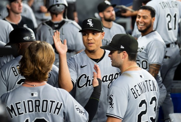 White Sox reliever Wikelman González, center, high-fives teammates in the dugout after making his major-league debut against the Blue Jays in the seventh inning on Friday, June 20, 2025, in Toronto. (Mark Blinch/Getty Images)