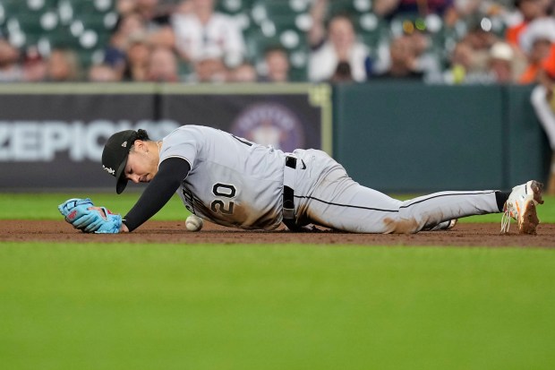 White Sox third baseman Miguel Vargas lies on the ground after committing an error while trying to field a ground ball by the Astros' Jeremy Peña during the third inning on June 12, 2025, in Houston. (Photo/David J. Phillip/AP)