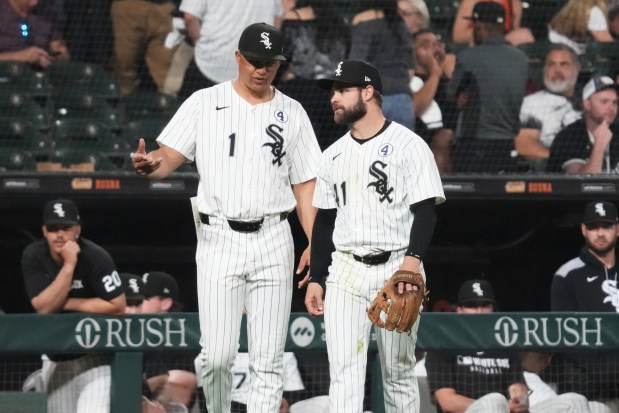 Chicago White Sox manager Will Venable, left, talks with relief pitcher Vinny Capra during the ninth inning of a baseball game against the Detroit Tigers in Chicago, Monday, June 2, 2025. (AP Photo/Nam Y. Huh)