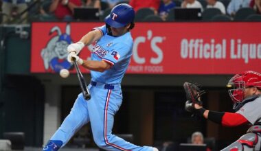 Texas Rangers' Josh Smith, left, hits a double that scored teammates Marcus Semien and Sam Haggerty in front of St. Louis Cardinals catcher Pedro Pagés during the second inning of a baseball game, Sunday, June 1, 2025, in Arlington, Texas. (AP Photo/LM Otero)