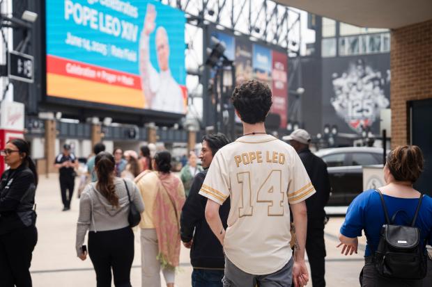 Ethan Peebles wears a Pope Leo jersey during the Archdiocese...