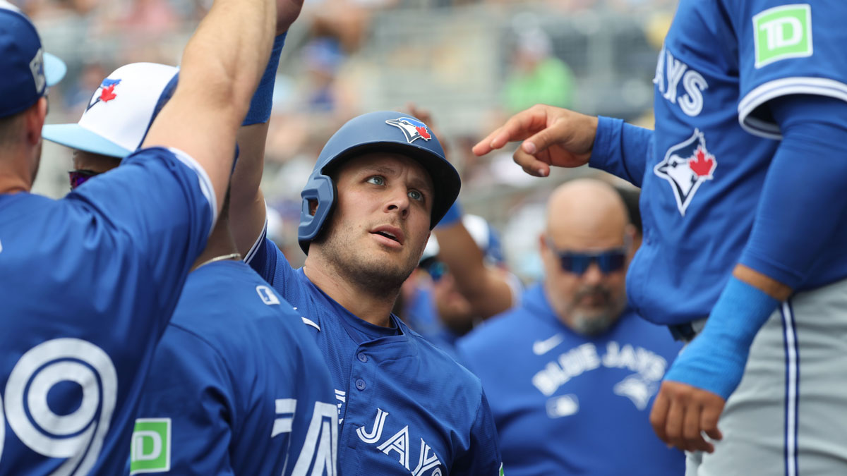 Mar 9, 2025; Port Charlotte, Florida, USA; Toronto Blue Jays outfielder Daulton Varsho (5) is congratulated in the dugout after he scored a run during the first inning against the Tampa Bay Rays at Charlotte Sports Park.