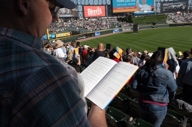 CHICAGO, ILLINOIS – JUNE 14: Guests attend mass at Rate...