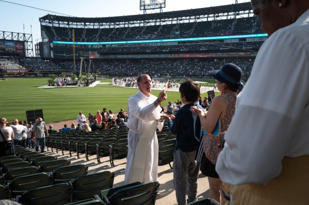 CHICAGO, ILLINOIS – JUNE 14: A parishioner receives communion during...