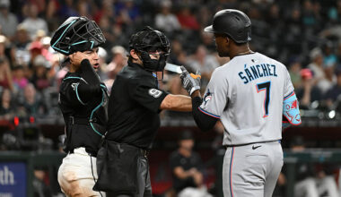 Home plate umpire Alex MacKay #9 gets in between Jose Herrera #11 of the Arizona Diamondbacks...