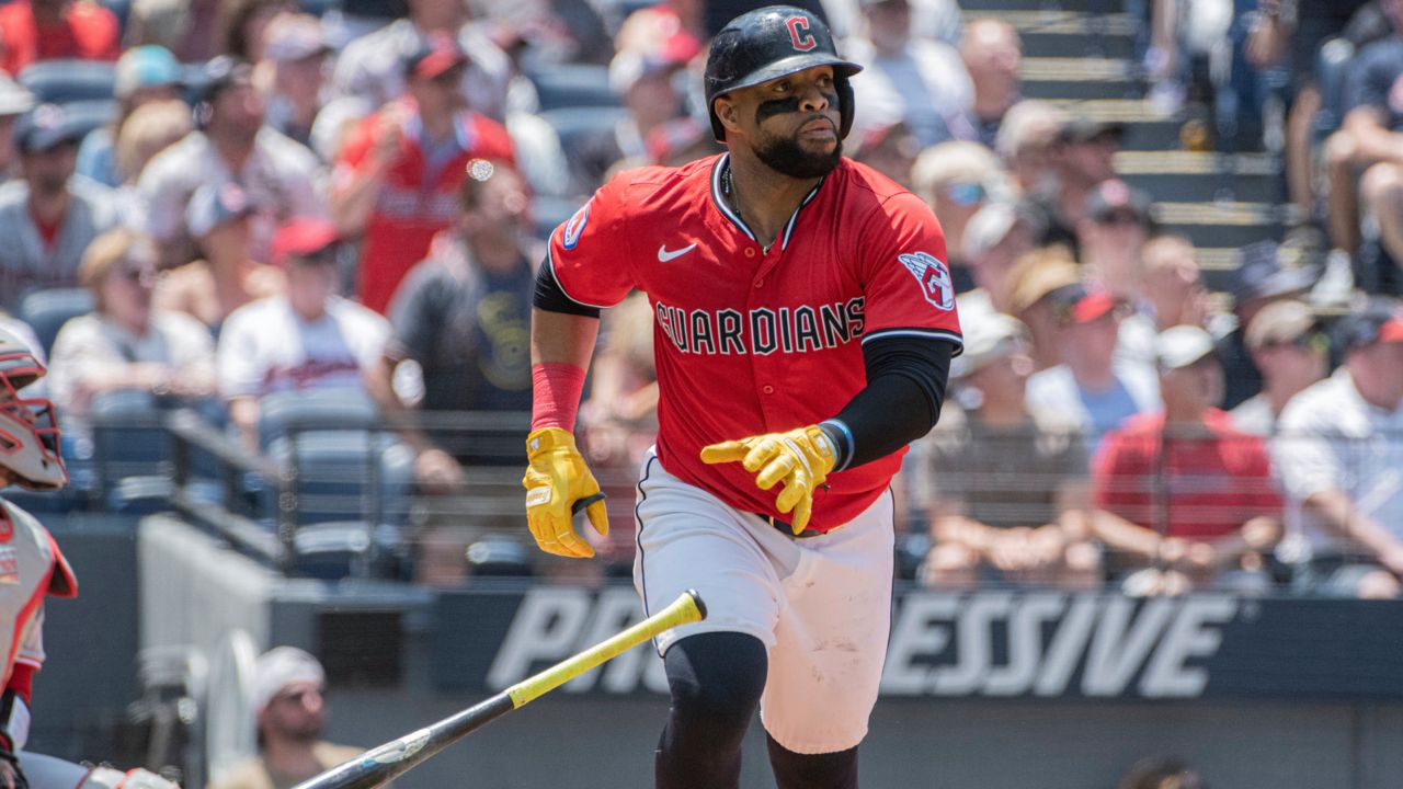 Cleveland Guardians' Carlos Santana watches his three-run home run off Cincinnati Reds starting pitcher Nick Lodolo during the third inning of a baseball game, Wednesday, June 11, 2025, in Cleveland.