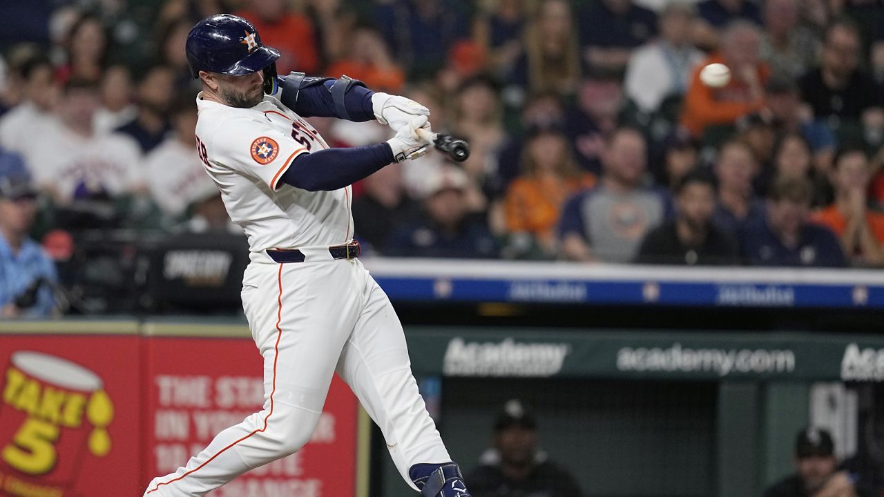 Houston Astros' Christian Walker hits a two-run double against the Chicago White Sox during the third inning of a baseball game Wednesday, June 11, 2025, in Houston. (AP Photo/David J. Phillip)