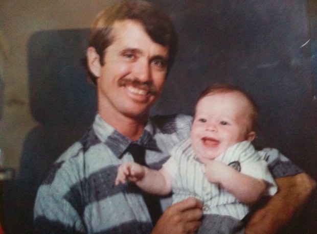 Tim Hill is pictured as a child with his father, Jerry Hill, in an undated family photo. (Courtesy of the Hill family)