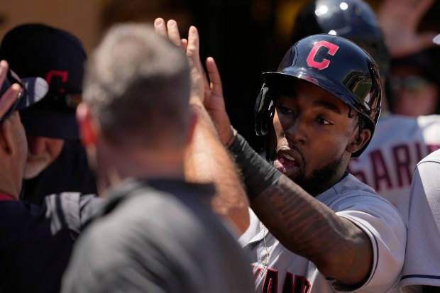 Cleveland Indians right fielder Daniel Johnson of Vallejo is congratulated by teammates Saturday after scoring a run on sacrifice fly ball by Amed Rosario during the fifth inning. (Tony Avelar-Associated Press)