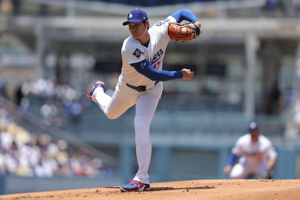 Los Angeles Dodgers starting pitcher Shohei Ohtani follows through on a throw to a Washington Nationals batter during the first inning of a baseball game in Los Angeles, Sunday, June 22, 2025. (AP Photo/Jessie Alcheh)