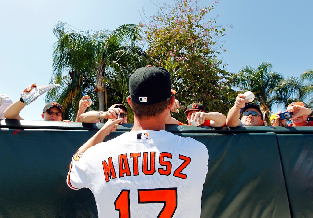 Baltimore Orioles' Brian Matusz signs autographs for fans prior to a spring training baseball game against the Boston Red Sox Saturday, March 27, 2010, in Sarasota, Fla.