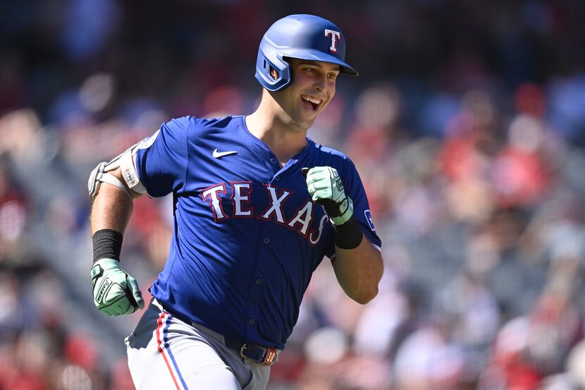 FILE - Texas Rangers' Nathaniel Lowe runs the bases after hitting a home run during the...