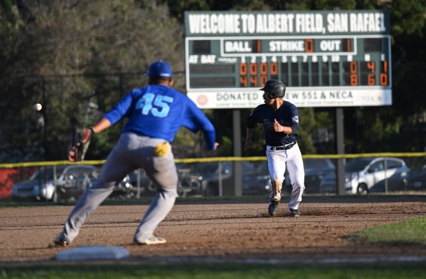 Mark Hernandez of the San Rafael Pacifics heads to third...