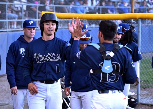 San Rafael Pacifics outfielder Aki Buckson (1) is greeted by...