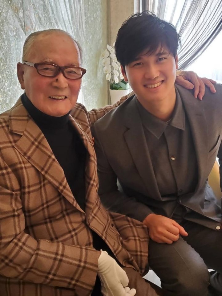 Photo of an older man and a younger man sitting together.