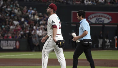 Arizona Diamondbacks pitcher Corbin Burnes, left, leaves a baseball game against the Washington Nat...