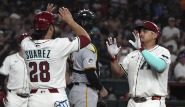 Arizona Diamondbacks' Josh Naylor, right, celebrates with Eugenio Suárez...