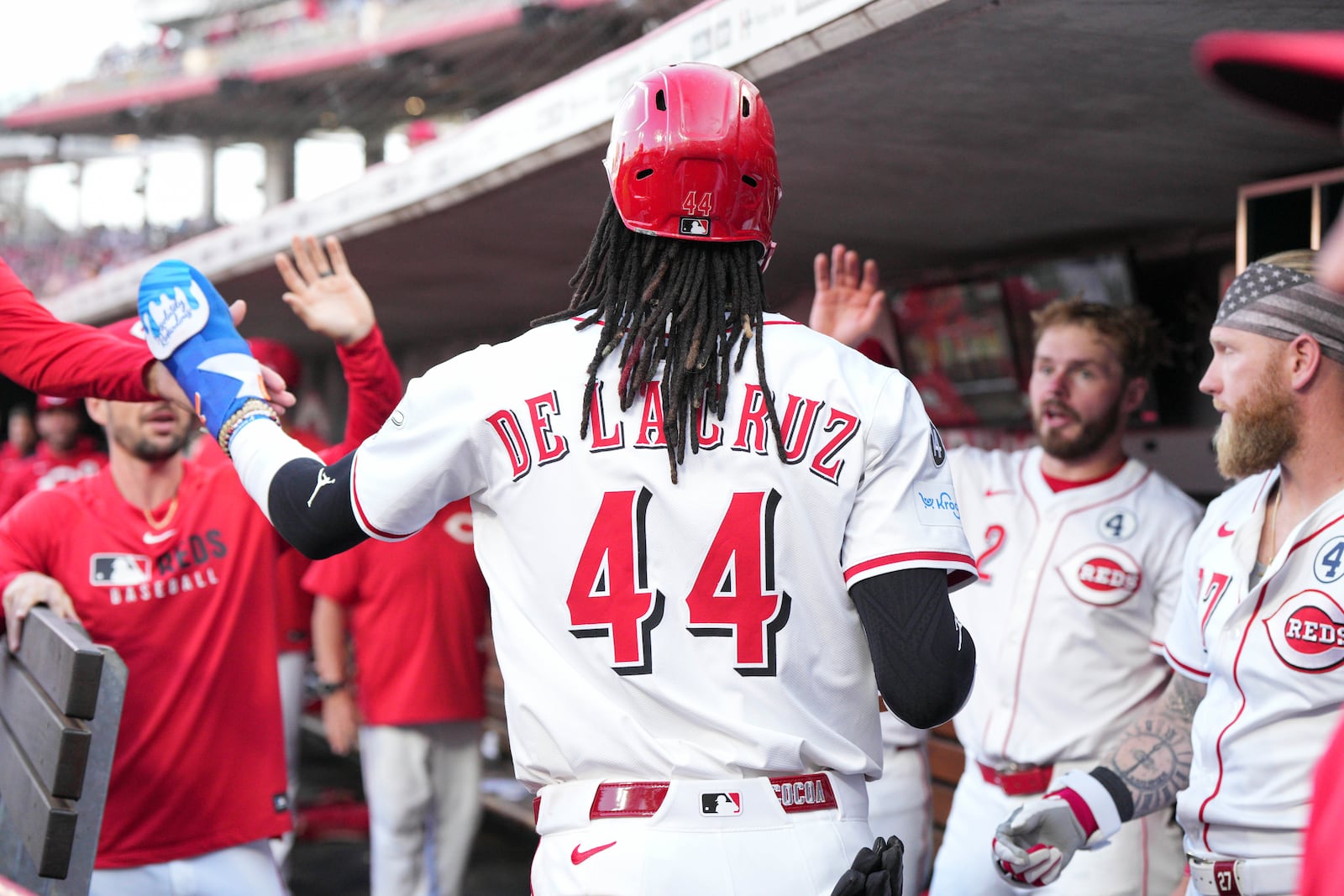 Cincinnati Reds' Elly De La Cruz (44) celebrates with teammates after scoring on a single hit by Spencer Steer during the first inning of a baseball game against the Milwaukee Brewers, Monday, June 2, 2025, in Cincinnati. (AP Photo/Jeff Dean)