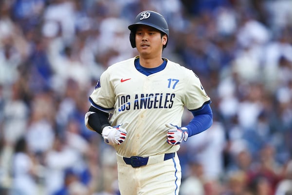 Los Angeles Dodgers designated hitter Shohei Ohtani runs towards home plate after hitting a home run during the first inning of a baseball game against the San Francisco Giants in Los Angeles, Saturday, June 14, 2025. (AP Photo/Jessie Alcheh)