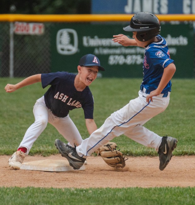 Ashland’s Conner Damiter (5) goes to tag Upper Schuylkill’s Jax...
