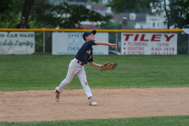 Ashland’s Conner Damiter (5) throws the ball to first base...