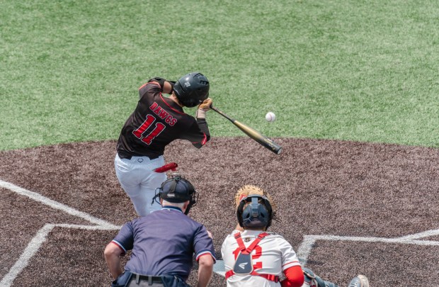 Tri-Valley junior Jason Stewart (11) connects with a pitch as...