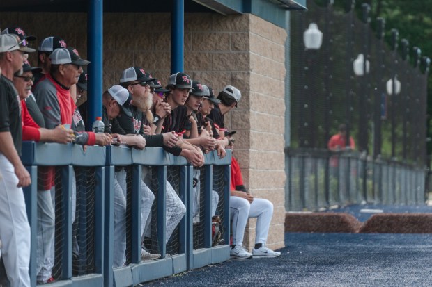 The Tri-Valley baseball team watches from the dugout as Tri-Valley...