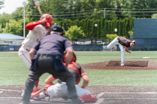 Tri-Valley junior Gavin Klock (15) delivers a pitch as Tri-Valley...