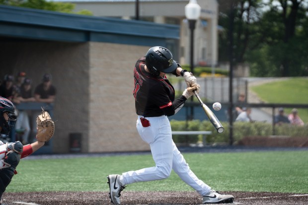 Tri-Valley junior Jason Stewart (11) connects with a pitch as...