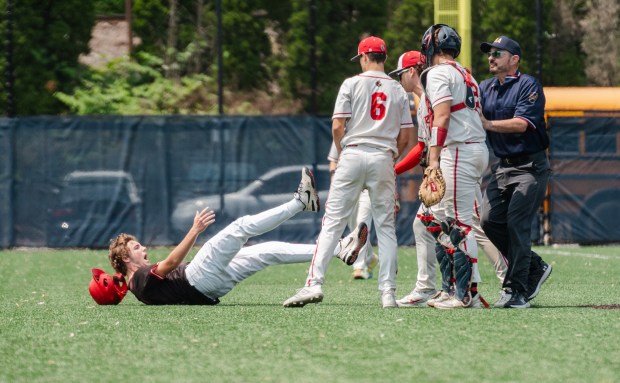 Tri-Valley junior Owen Miller (2) falls to the ground after...