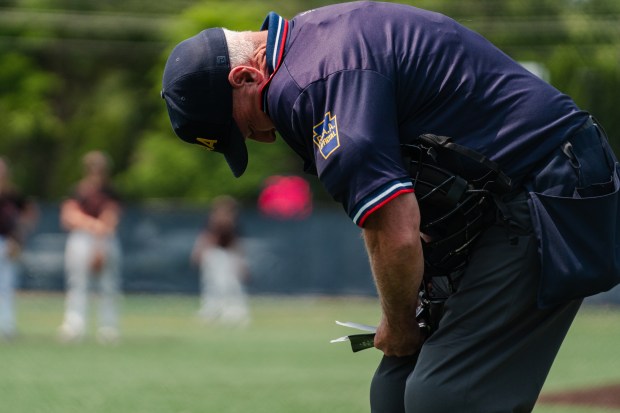 An umpire writes in his notebook as Tri-Valley faces Holy...