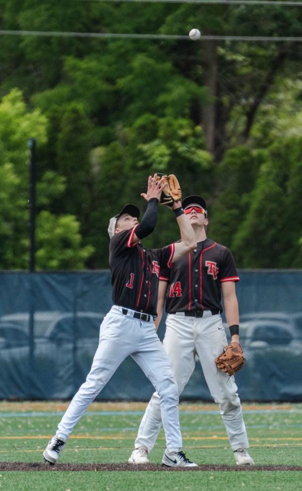 Tri-Valley junior Jason Stewart (11) catches a fly ball as...